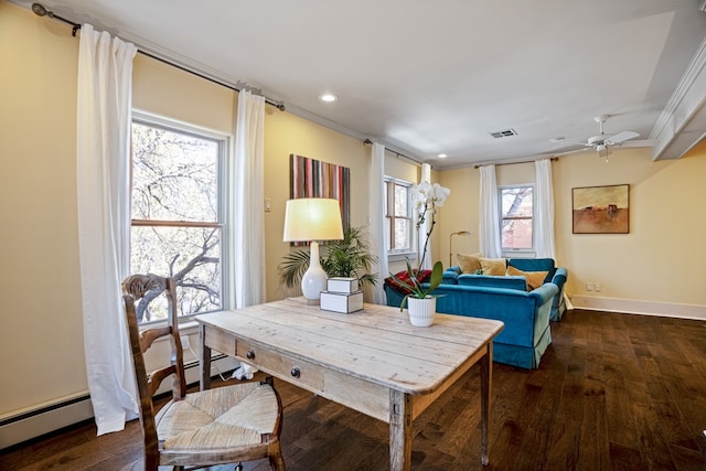 dining space with ceiling fan, ornamental molding, a wealth of natural light, and dark wood-type flooring