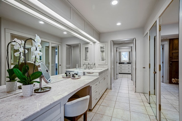 bathroom with tile floors and vanity