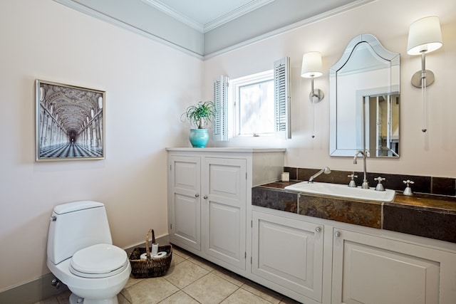 bathroom with vanity, tile floors, toilet, and ornamental molding