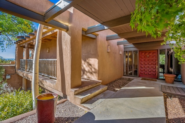 entrance to property featuring a patio