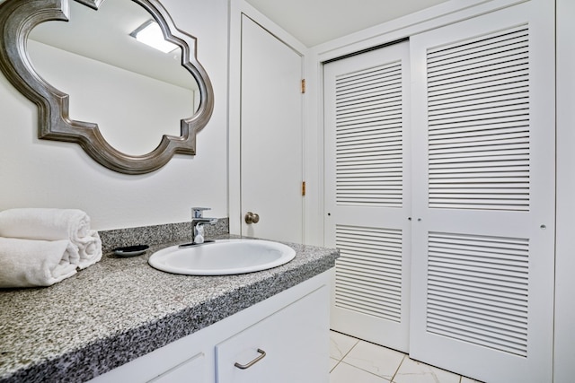 bathroom with vanity and tile flooring