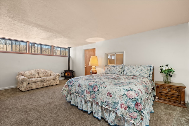 carpeted bedroom with a textured ceiling and a wood stove