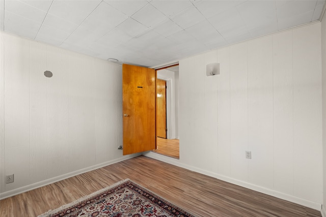 unfurnished room with dark hardwood / wood-style flooring