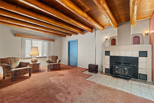 carpeted living room with beam ceiling, a wood stove, a tile fireplace, and wood ceiling