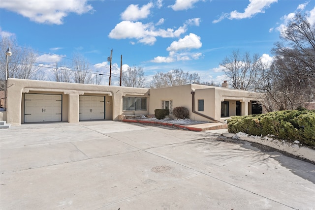 pueblo-style home with a garage