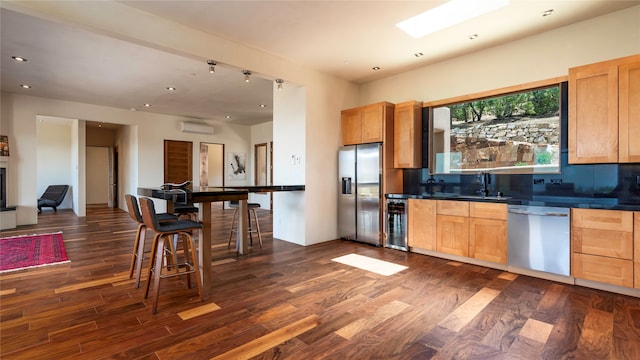 kitchen featuring tasteful backsplash, appliances with stainless steel finishes, dark wood-type flooring, and sink