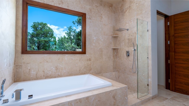 bathroom featuring tile flooring and shower with separate bathtub