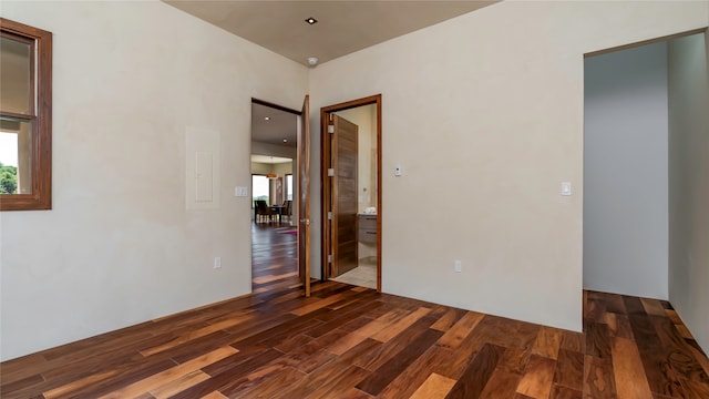 unfurnished room with dark wood-type flooring