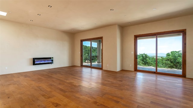 unfurnished living room with light hardwood / wood-style floors