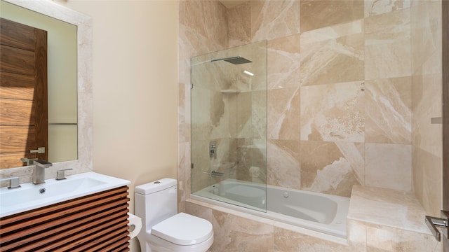 full bathroom featuring vanity, bath / shower combo with glass door, and toilet