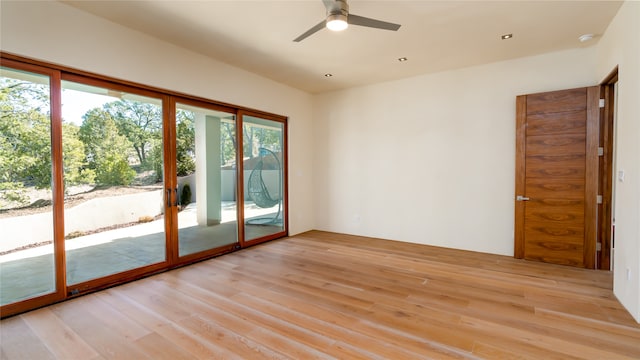 empty room with ceiling fan and light wood-type flooring