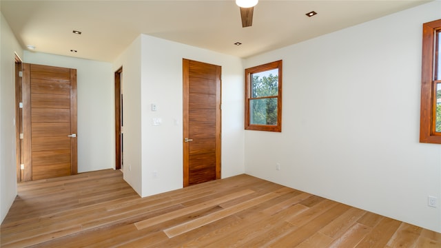 unfurnished bedroom featuring ceiling fan and light hardwood / wood-style flooring