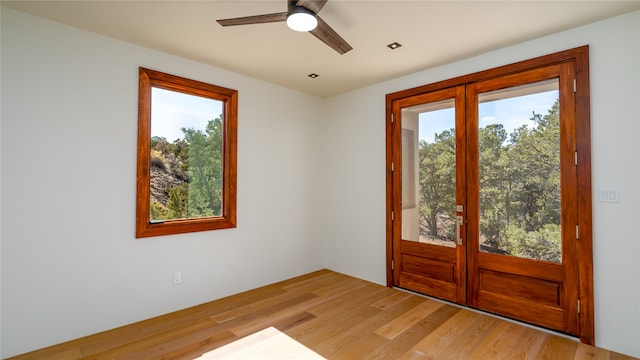 interior space featuring plenty of natural light, ceiling fan, and light wood-type flooring