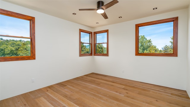 empty room with light hardwood / wood-style flooring and ceiling fan