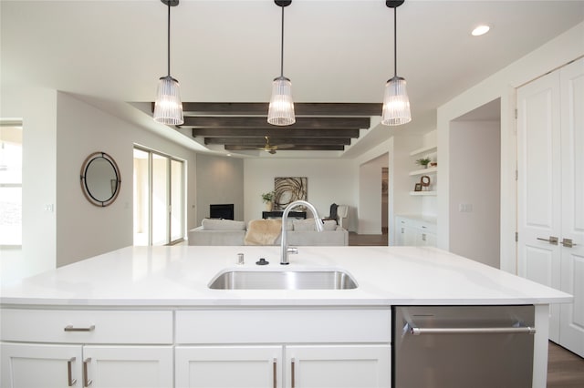 kitchen featuring stainless steel dishwasher, sink, hanging light fixtures, and white cabinets