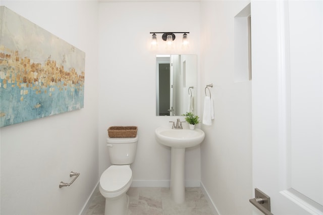 bathroom featuring toilet and tile flooring