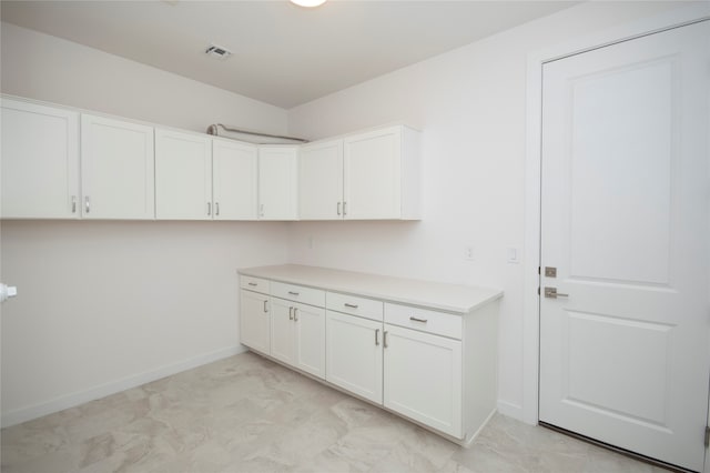 laundry room with light tile flooring