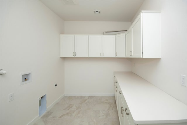 clothes washing area with washer hookup, hookup for an electric dryer, cabinets, and light tile floors