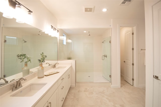 bathroom with double vanity, a shower with shower door, and tile flooring