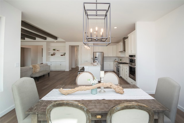 dining space featuring dark wood-type flooring, built in features, a notable chandelier, and beam ceiling