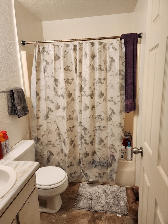 bathroom with toilet, tile flooring, and vanity