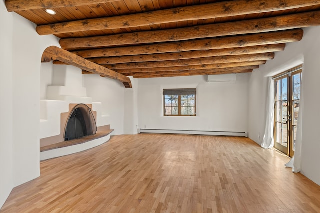 unfurnished living room with an AC wall unit, beamed ceiling, light hardwood / wood-style flooring, a baseboard radiator, and wooden ceiling