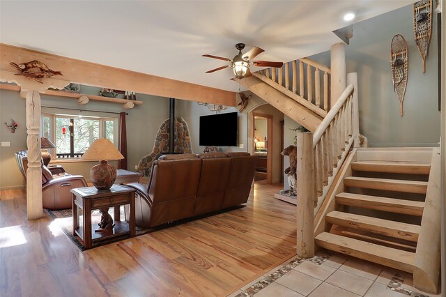 living room featuring a wood stove, a wealth of natural light, and light wood-type flooring