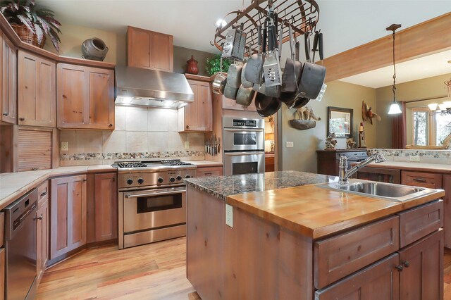 kitchen featuring french doors, decorative light fixtures, a notable chandelier, and light hardwood / wood-style flooring