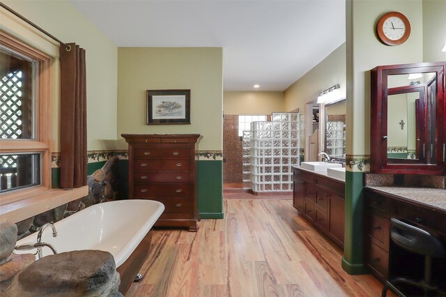 bedroom with ceiling fan, wooden ceiling, a fireplace, beam ceiling, and hardwood / wood-style flooring