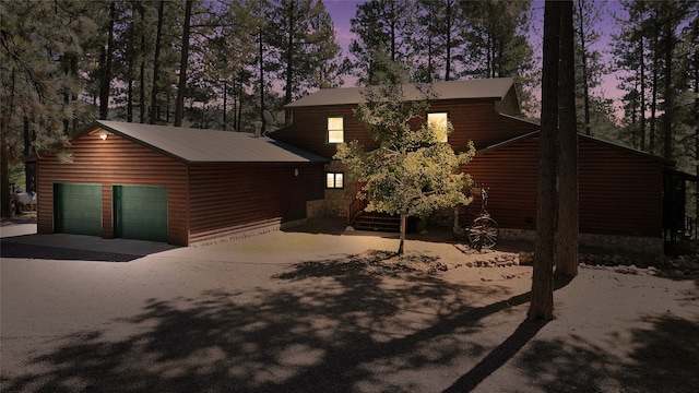 log home featuring an outdoor structure and a garage