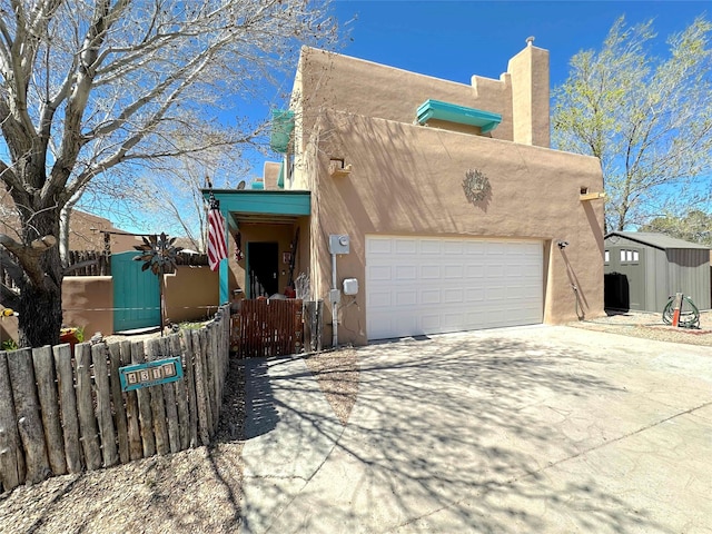 pueblo-style home featuring a garage