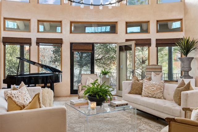 living room with light tile patterned flooring and a towering ceiling