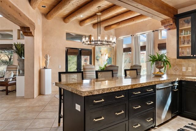 kitchen featuring a chandelier, hanging light fixtures, wooden ceiling, a kitchen breakfast bar, and beam ceiling