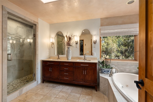 bathroom with vanity and shower with separate bathtub