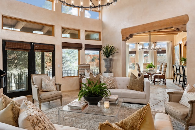 sunroom / solarium featuring a healthy amount of sunlight and a chandelier