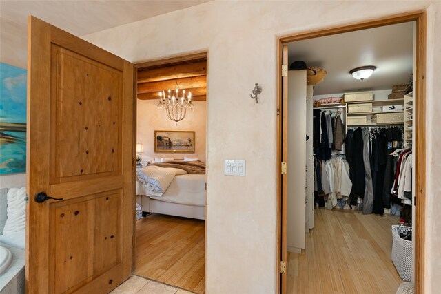 bathroom with a notable chandelier and hardwood / wood-style floors