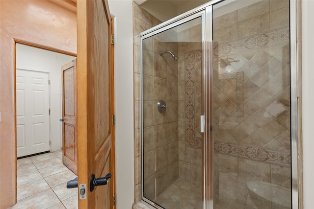 bathroom featuring a shower with shower door and tile patterned flooring