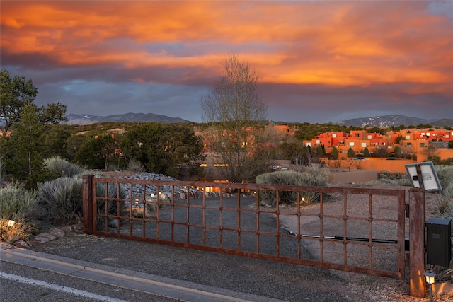 gate at dusk with a mountain view