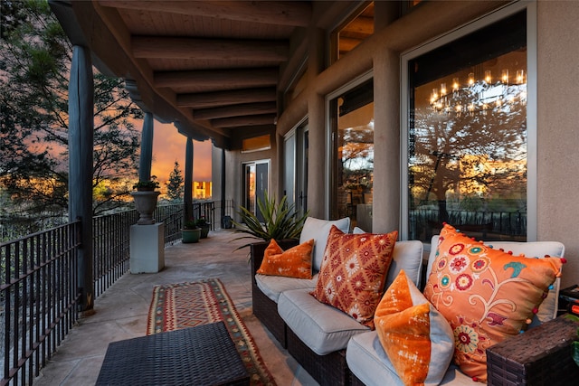 patio terrace at dusk with a balcony and an outdoor hangout area