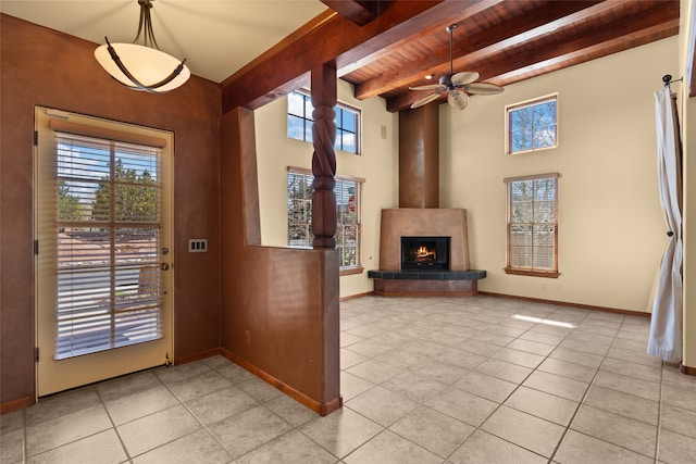 foyer with ceiling fan, light tile patterned floors, wooden ceiling, and a healthy amount of sunlight