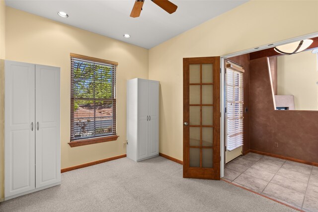 interior space featuring ceiling fan and light colored carpet