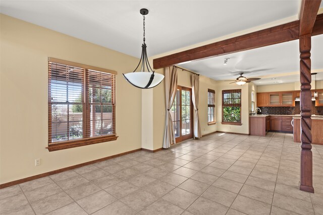 interior space with light tile patterned floors, sink, ceiling fan, and plenty of natural light