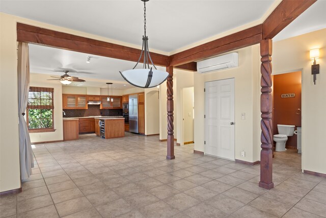 interior space featuring tasteful backsplash, an AC wall unit, decorative light fixtures, ceiling fan, and black oven