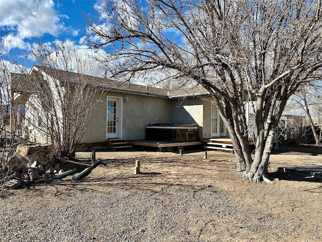 back of house with a deck