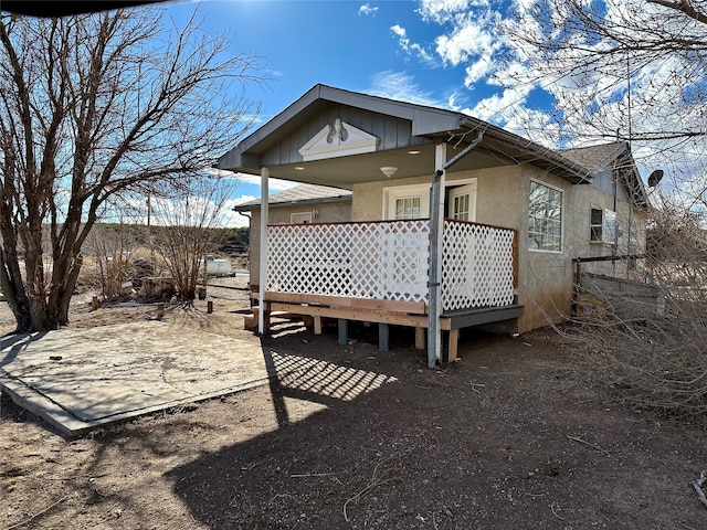 back of property with a wooden deck