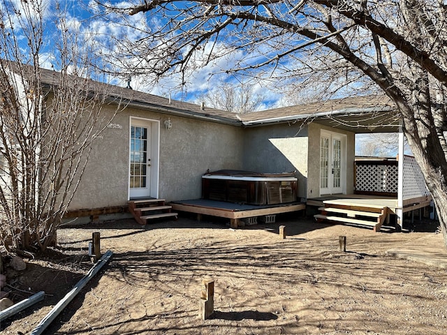 rear view of house with french doors and a wooden deck