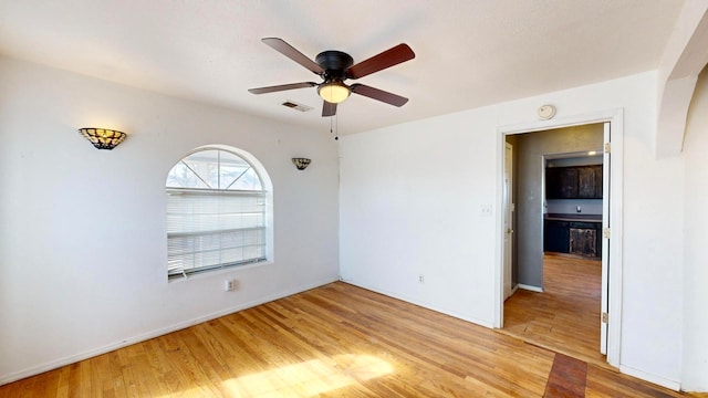 spare room featuring light hardwood / wood-style flooring and ceiling fan