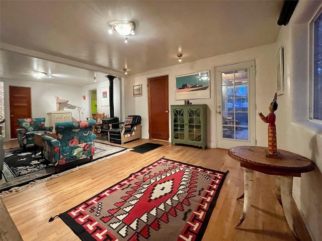 interior space with a wood stove and hardwood / wood-style floors