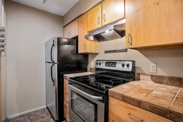 kitchen with electric stove and tile floors