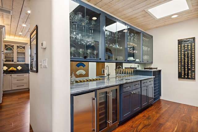 bar featuring wine cooler, tasteful backsplash, dark hardwood / wood-style flooring, dark stone counters, and wooden ceiling